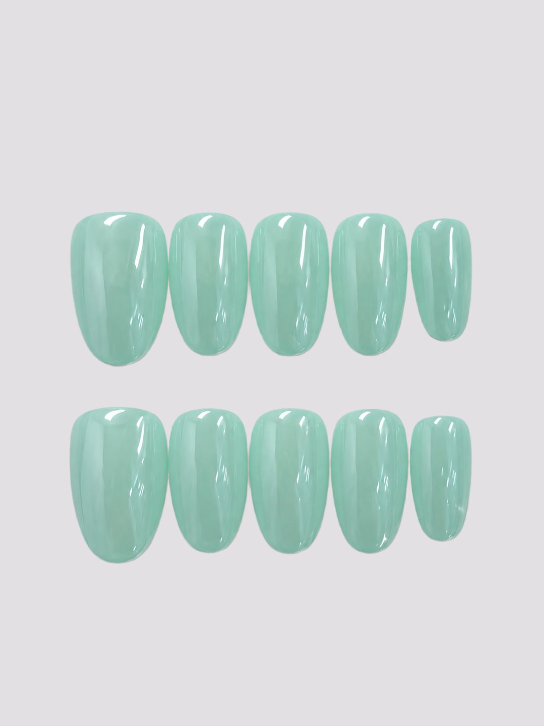 Mint Mirage short oval press-on nails – worn on hands