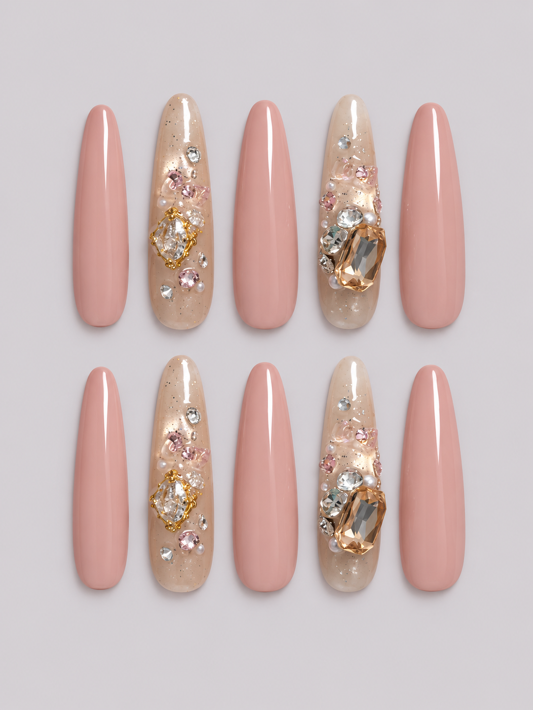 Champagne Bloom press-on nail set with blush pink nails and shimmering accent nails decorated with pink, clear and champagne-coloured gems.