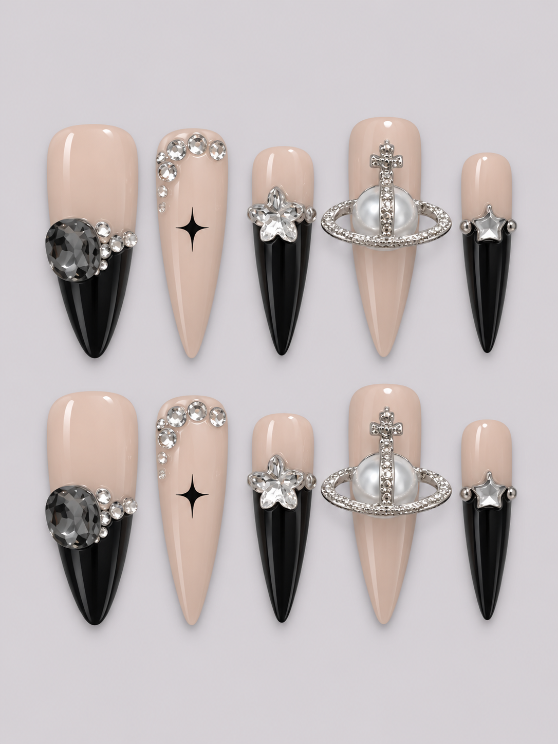 A set of 10 press-on nails arranged in two rows of five on a light gray background. The nails feature a split design with a nude beige top half and a glossy black pointed bottom half.