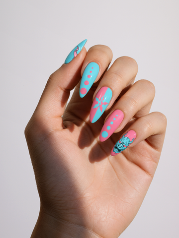 Urban Oni press-on nail set arranged in two rows, featuring pink and turquoise oni masks and dotted designs.