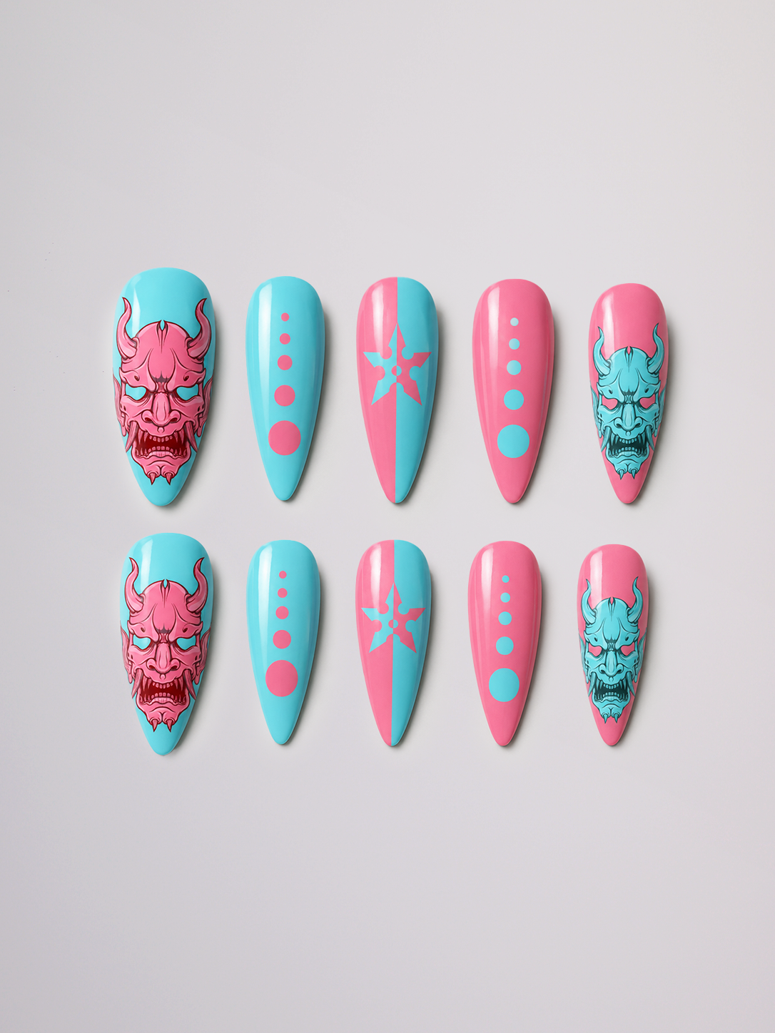 Urban Oni press-on nail set arranged in two rows, featuring pink and turquoise oni masks and dotted designs.