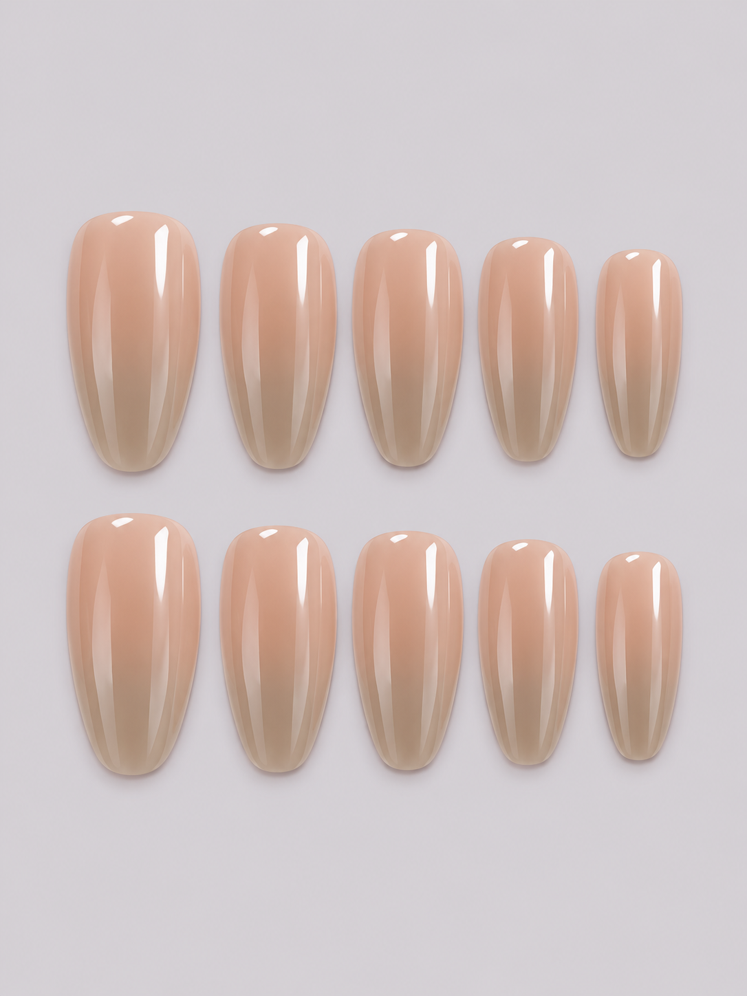 Hailey press-on nail set in a glossy nude shade with a pearly sheen, arranged in two rows.