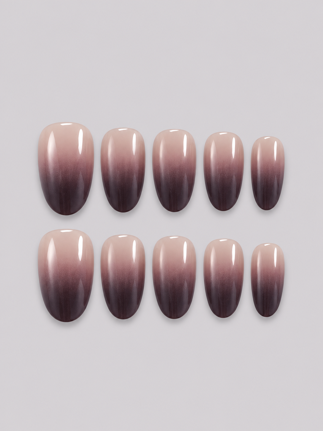 Blackcurrant press-on nail set with a glossy nude-to-deep-plum gradient, arranged in two rows.