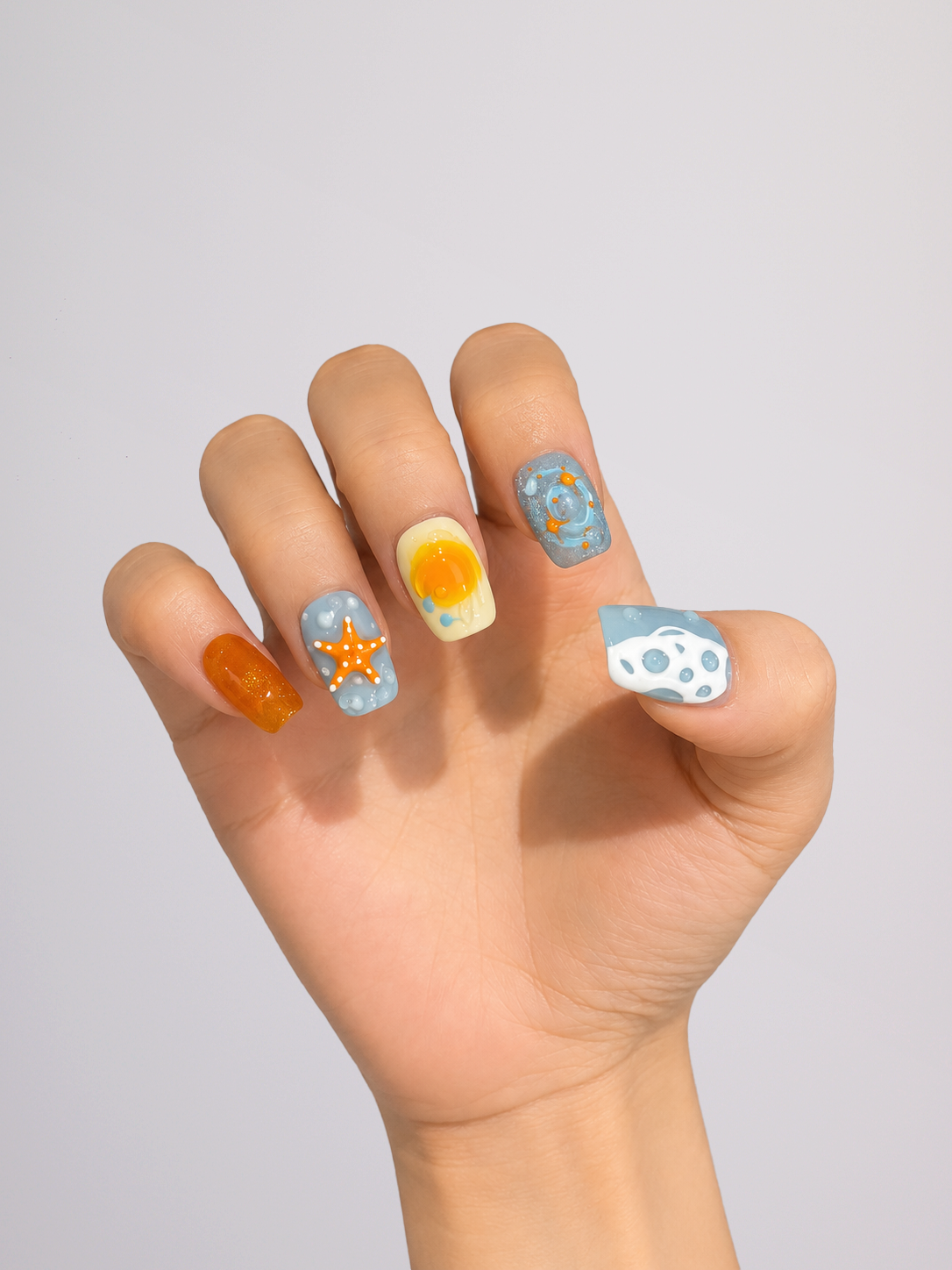 Woman wearing blue and orange floral short square press-on nails