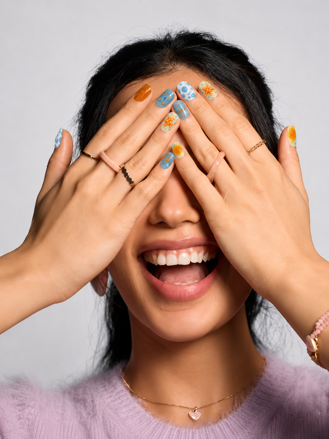 Woman wearing colourful blue and orange floral press-on nails
