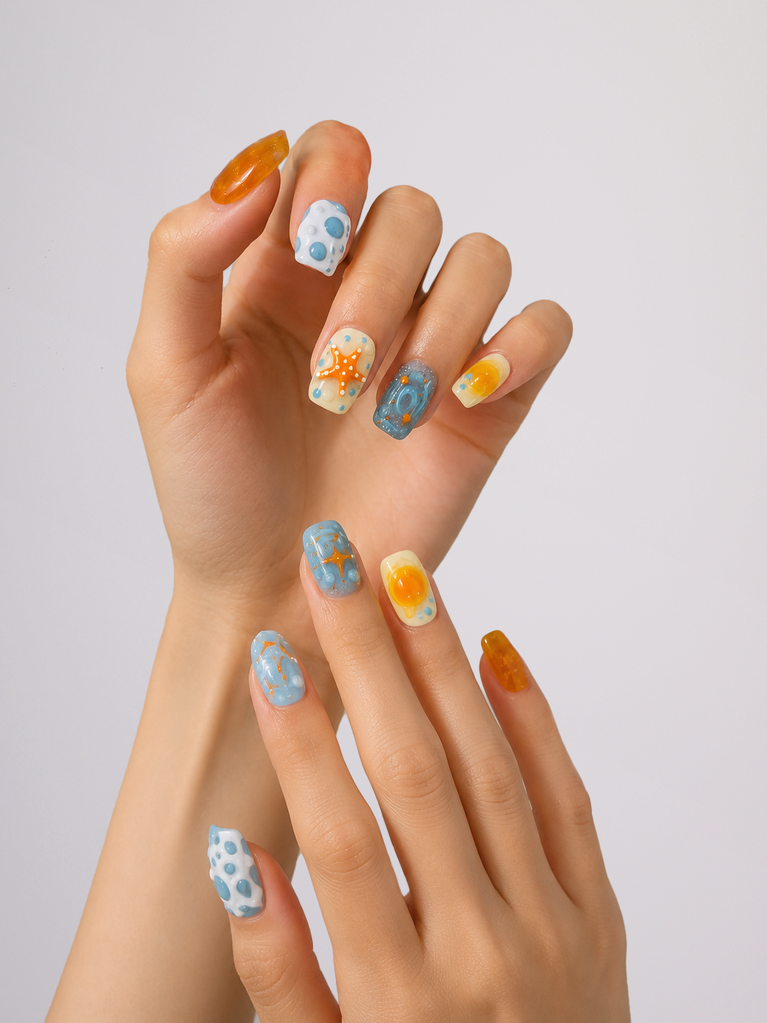 Woman wearing blue and orange floral short square press-on nails