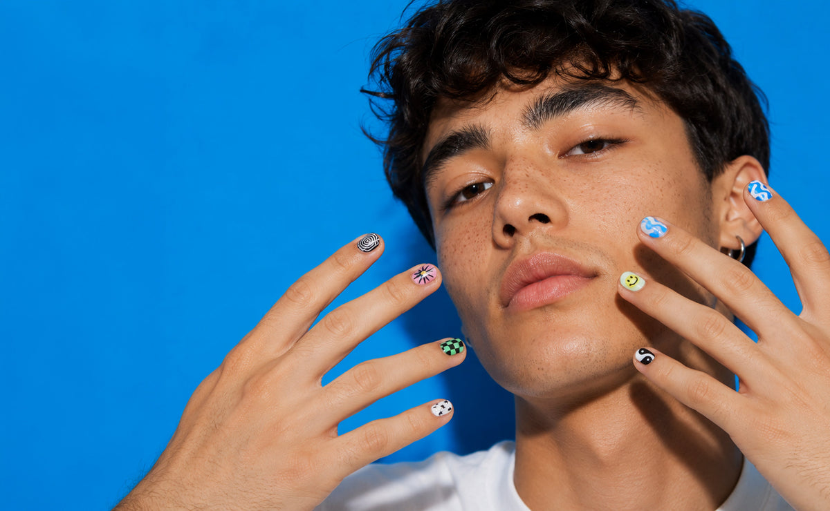 Person with colorful nail art against a blue background1621243260e1af0c20-2
